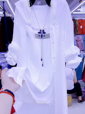 Elegant White Layered Outfit with Striking Blue Necklace